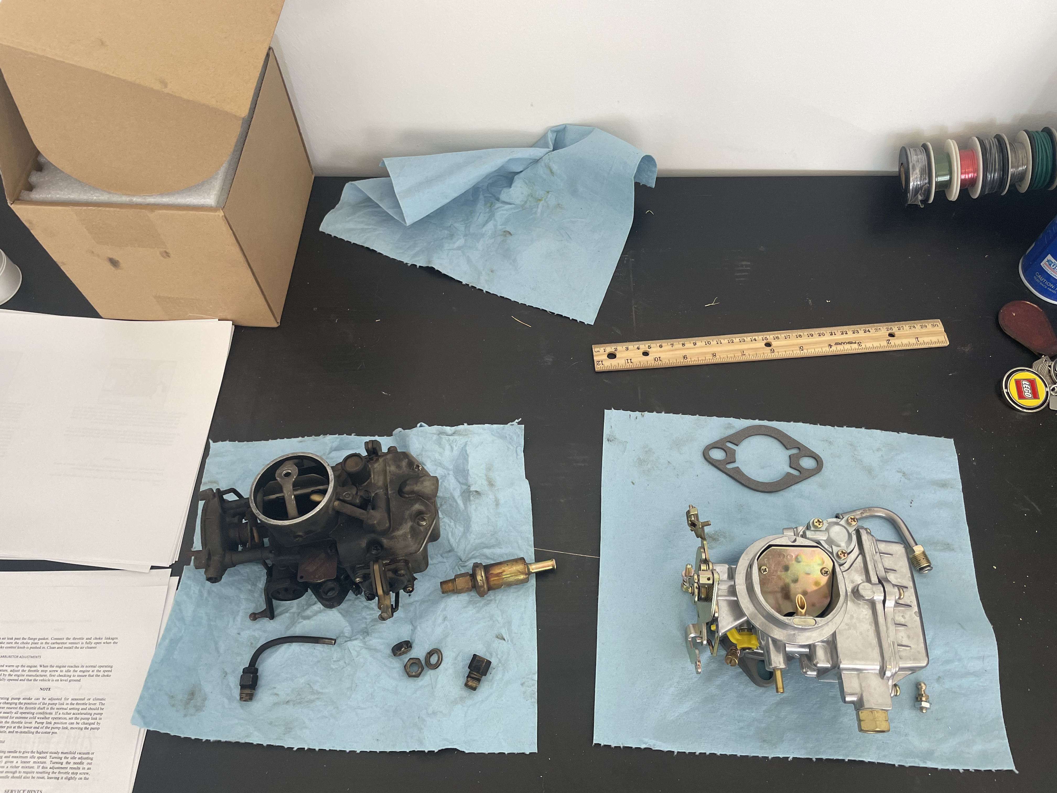 Side by side comparison of the two carburetors. The one on the left is the old Autolite, the one on the right is the Holley knockoff acquired from Amazon.